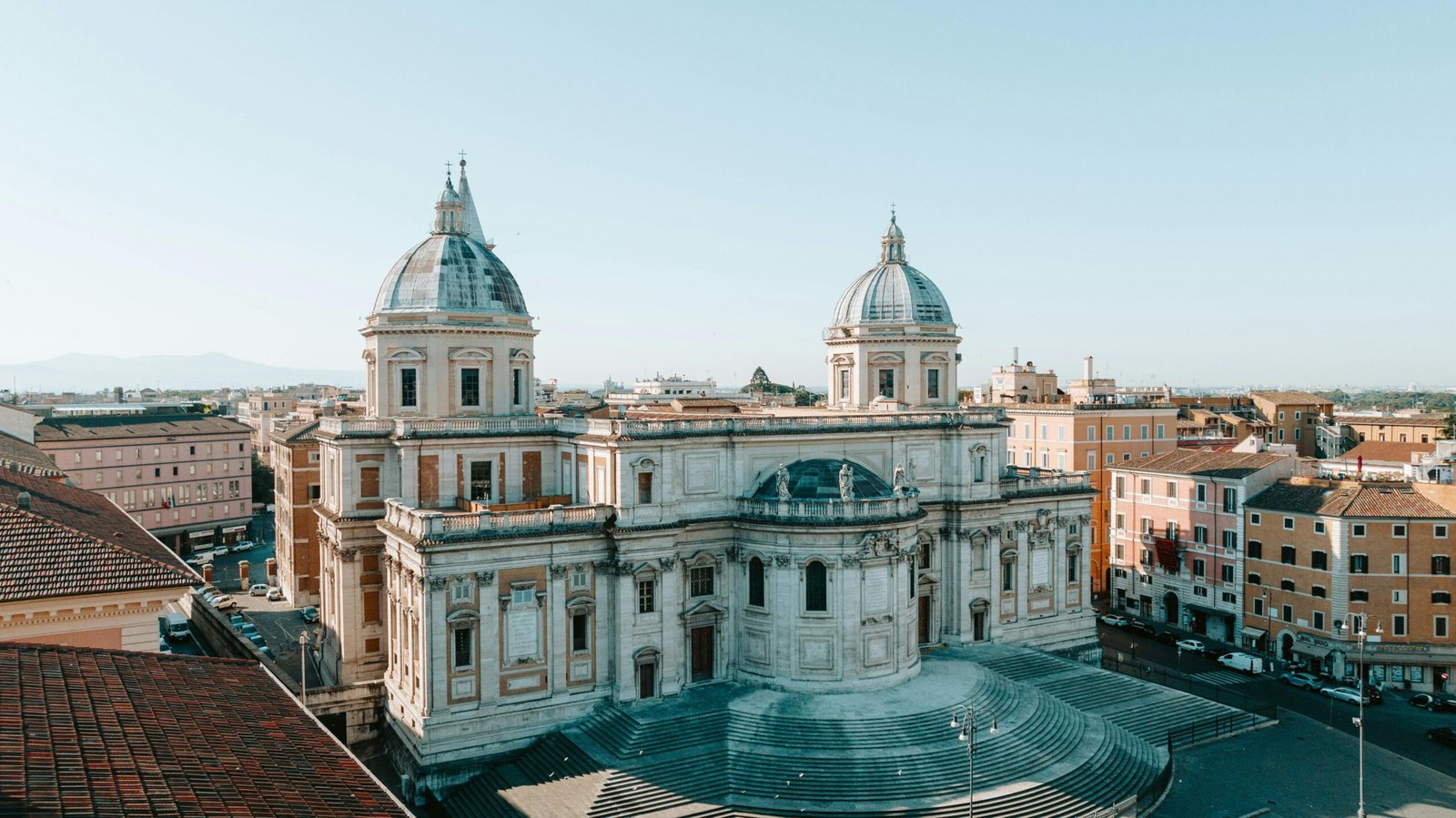 Aerial view of the majestic Basilica di Santa Maria Maggiore in Rome with clear skies.