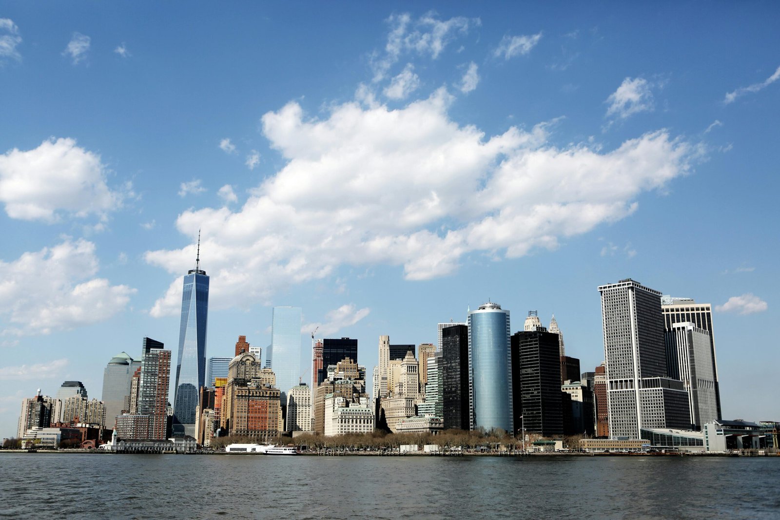 Stunning view of New York City's skyline featuring iconic skyscrapers against a blue sky.